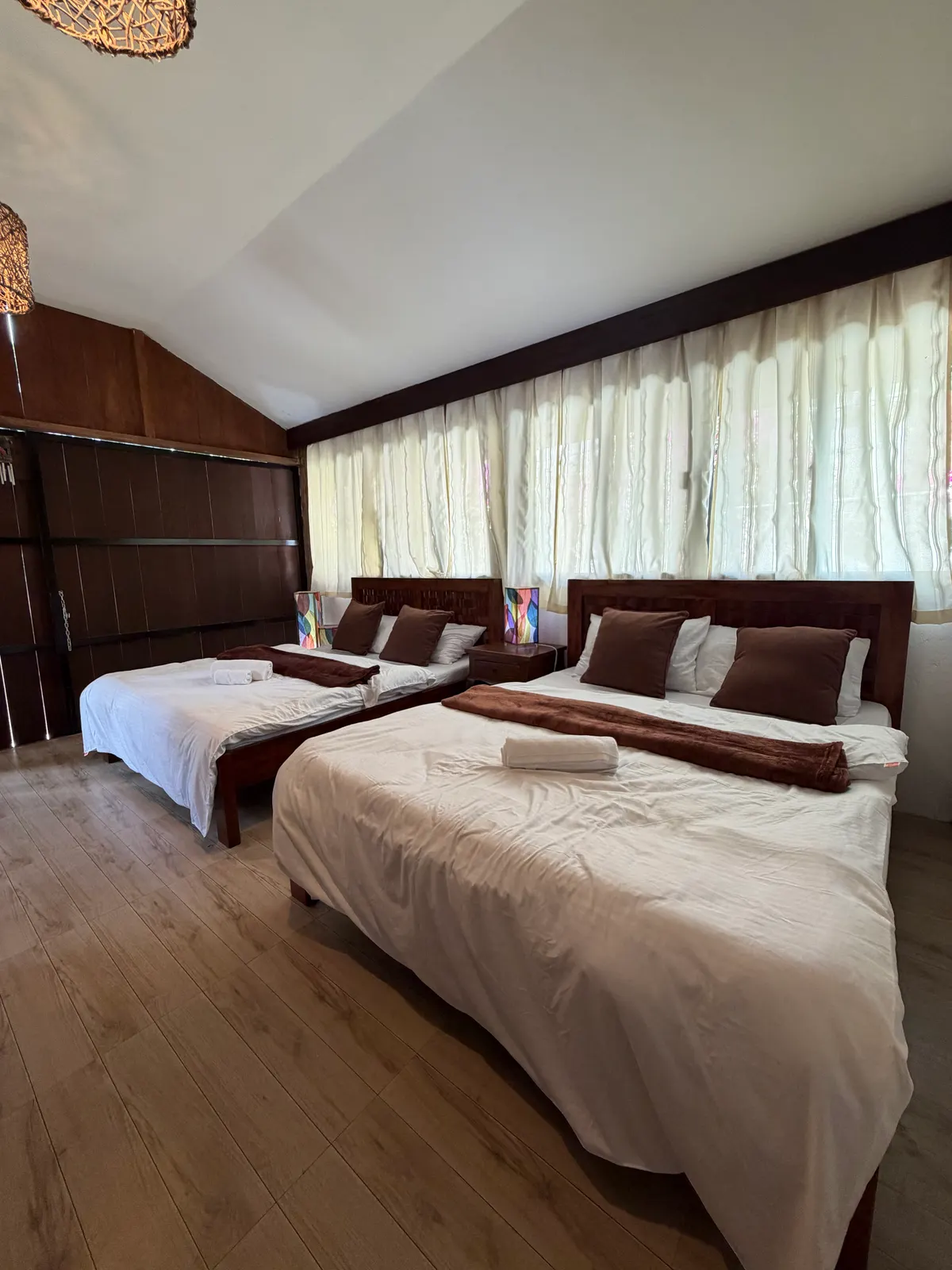 White linens and bed setup inside San Jose Cabins main cabin