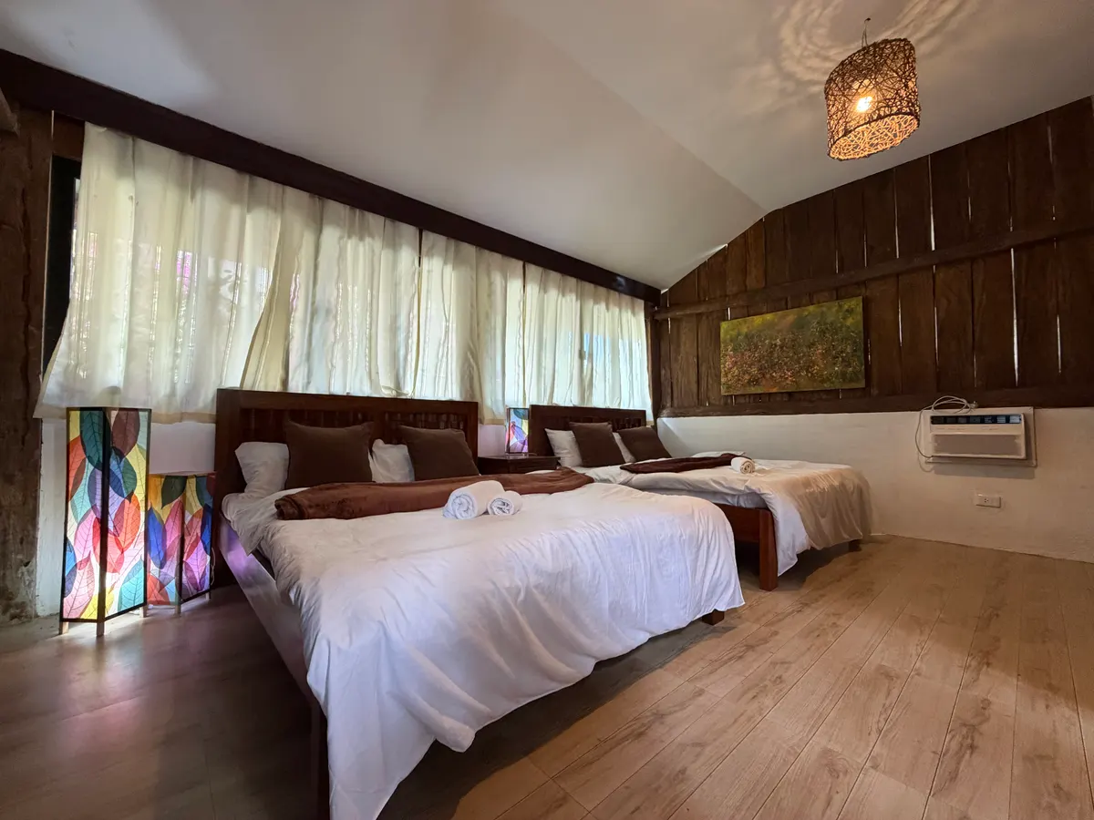 Cozy bed area inside the main cabin at San Jose Cabins